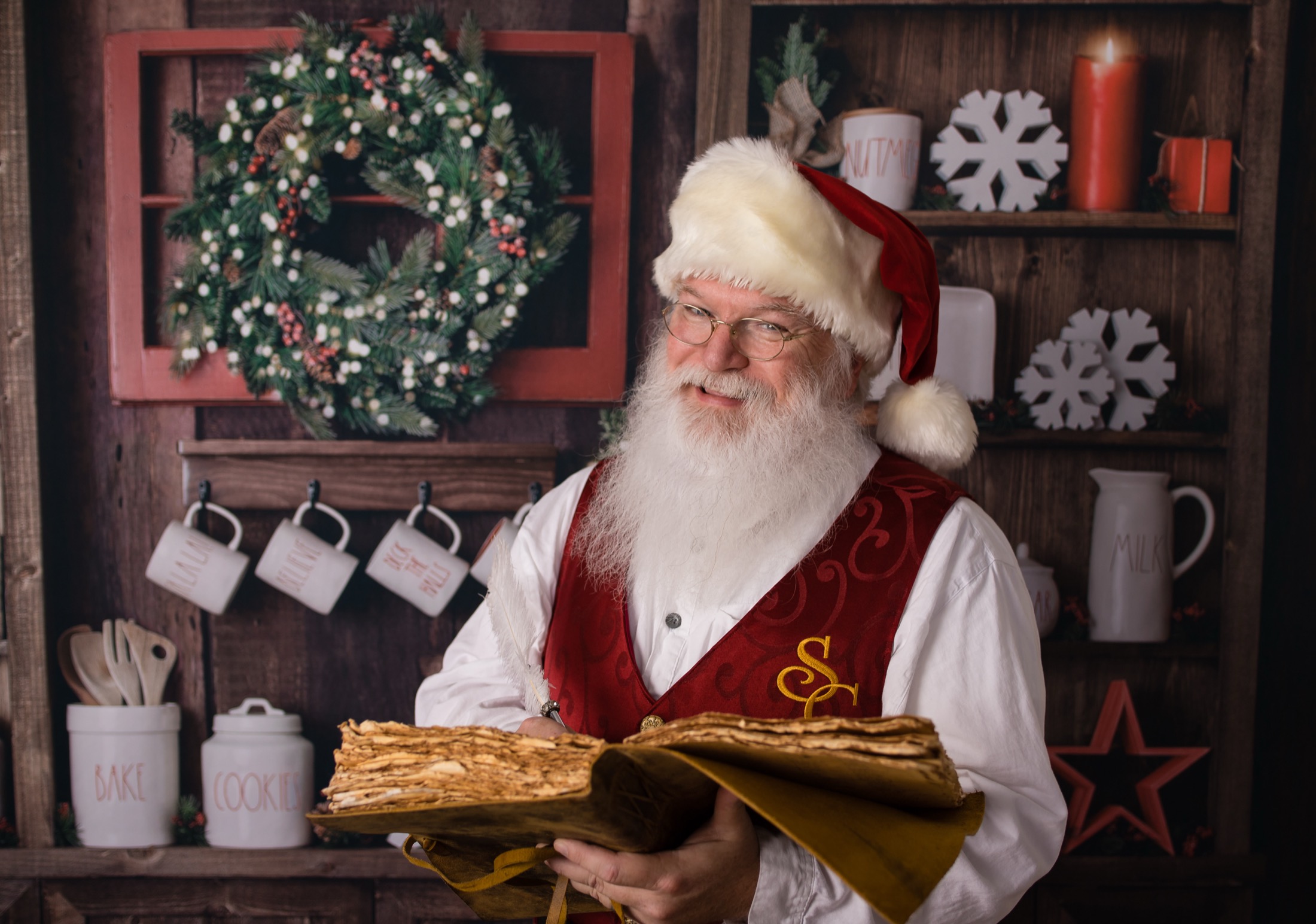 Santa reading from a large book in a warm North Pole setting